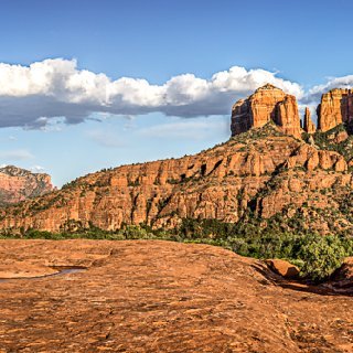 Cathedral Rock Overlook Panorama of Cathedral Rock and water pools with prickly pear cactus at Secret Slickrock in Sedona, AZ