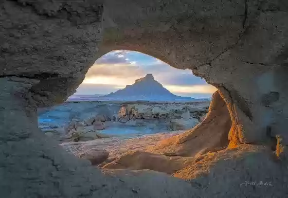 One Hole Arch 2 Arches framing Factory Butte near Hanksville, Utah