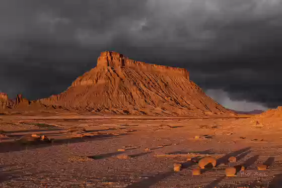 Coming Storm Dark storm clouds over Fafcdtory Butte at dawn.