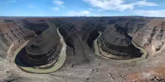 Goosencks State Park The Goosencks as seen from a drone 300 hundred feet above the parking lot at Gooseneck State Park.. Alhambra Rock is just visiible on the far left, and Monument...