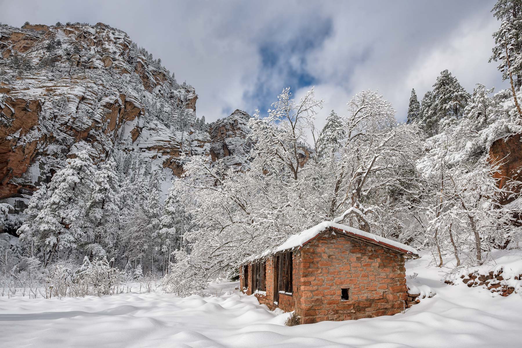 Remnant of Mayhew Lodge near the West Fork of Oak Creek trailhead covered in snow