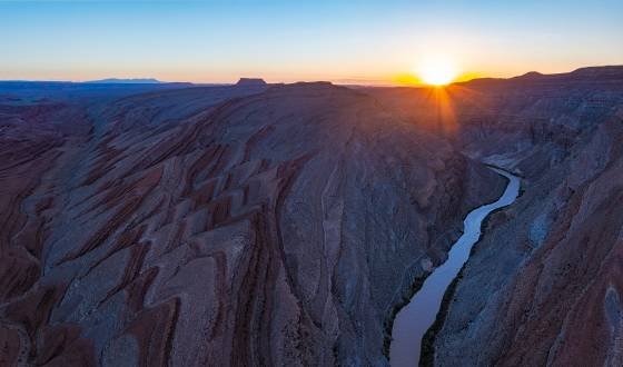 Sunrise over Raplee Ridge Raplee Ridge and the San Juan River seen at sunrise. Sugarloaf butte seen in the distance in the center of the image.